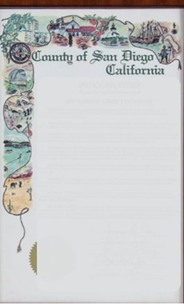 A decorative certificate from the County of San Diego, California, featuring illustrated coastal and historical scenes along the left border reminiscent of Santa Barbara County, with colorful text at the top. The document text is mostly faded and unclear.